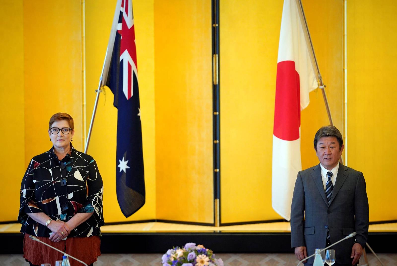 Australian Foreign Minister Marise Payne poses next to her Japanese counterpart Toshimitsu Motegi before their luncheon meeting in Tokyo on Wednesday. | POOL / VIA REUTERS