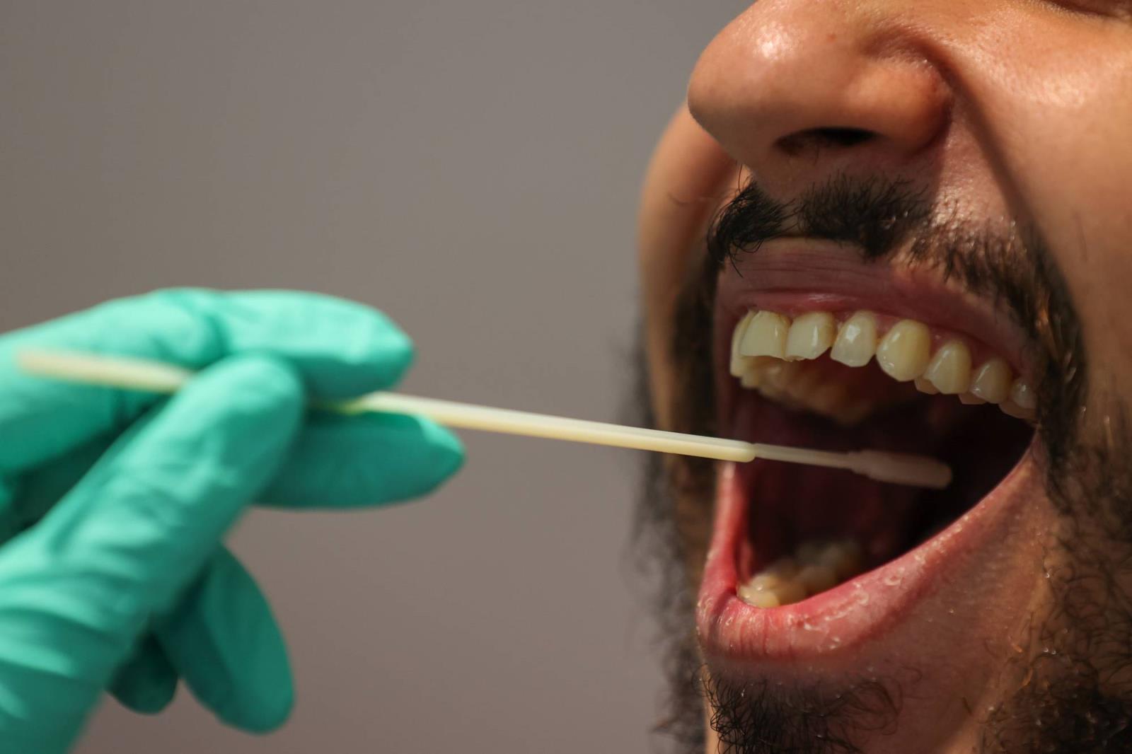 A traveler undergoes a polymerase chain reaction swab test at the COVID-19 test center run by Centogene NV at Frankfurt Airport in Germany. | BLOOMBERG